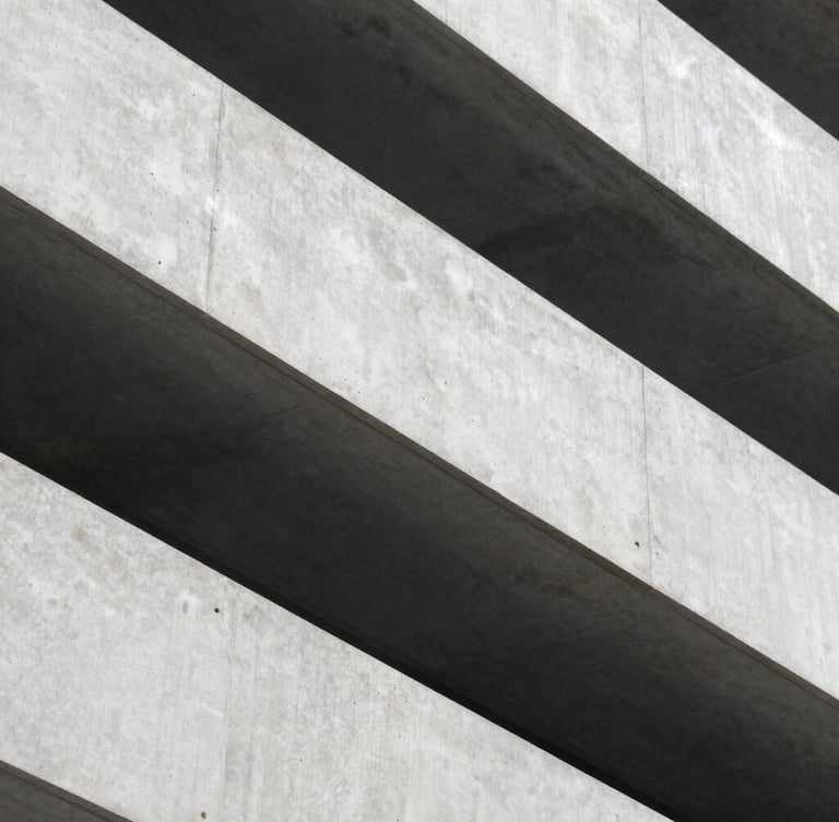 Macro shot of clean, sharp architectural concrete lines with dramatic shadows, cool diffused daylight, representing structure and corporate stability.