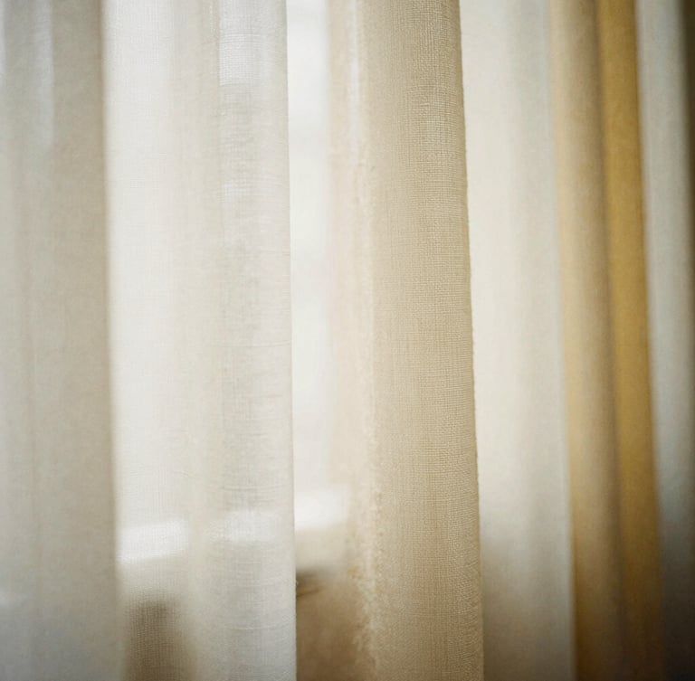 Macro photography of raw textile swatches in ivory, warm beige, and soft gold, soft morning window light, high-texture weave, medium format film