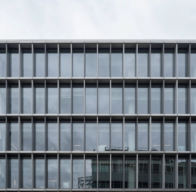 Minimalist architectural photography of a modern steel and glass corporate building facade, cool overcast daylight, deep charcoal and silver tones, sharp focus, 35mm