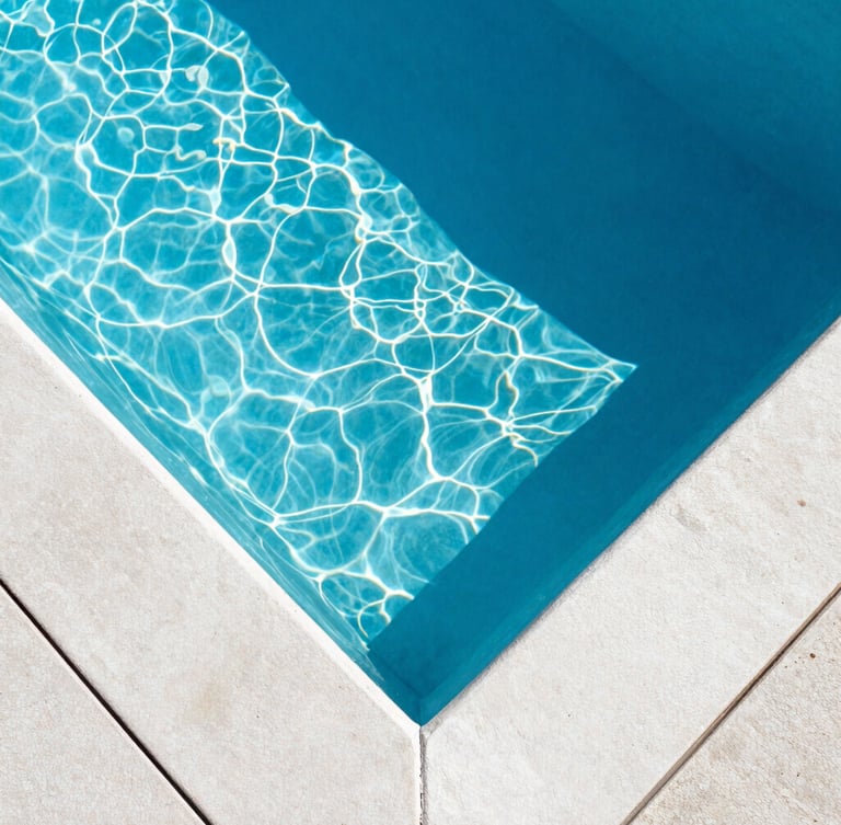 Top-down architectural view of a pristine, crystal-clear swimming pool, sharp geometric concrete lines, deep blue water with light caustics from bright midday Florida sun, 35mm lens.