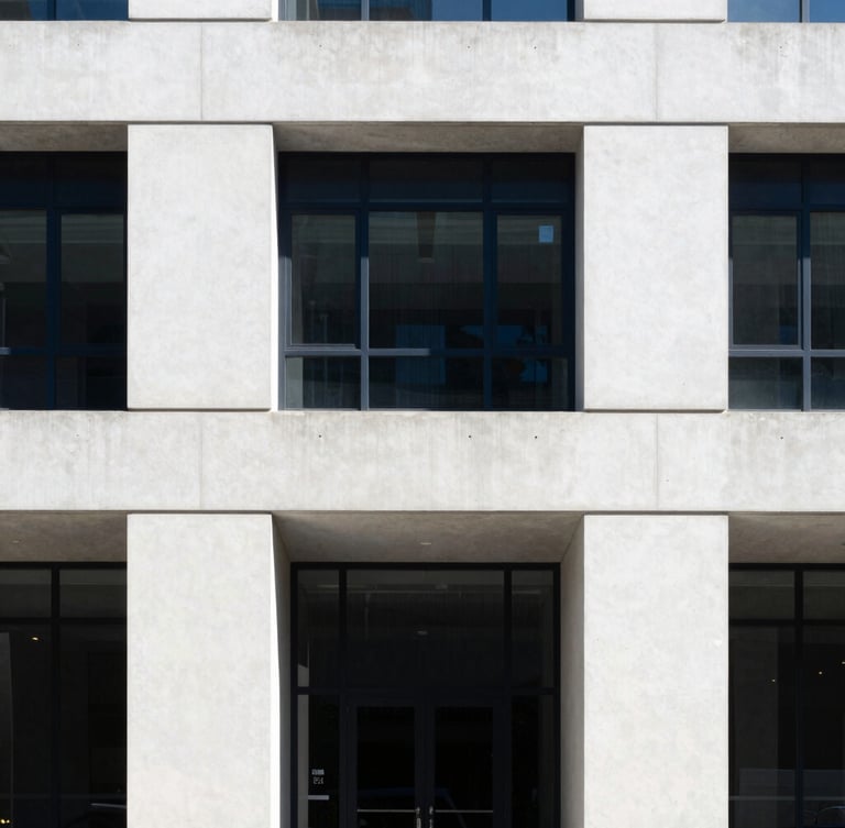 Sober architectural photography of a modern law office facade, clean concrete lines, cool natural daylight, sharp focus, 35mm lens