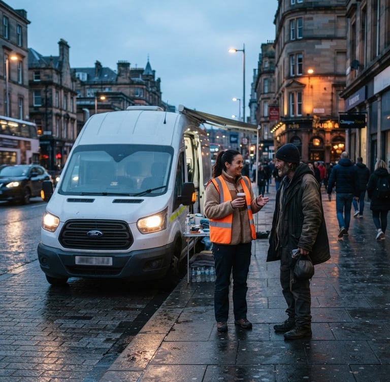 Wide shot of the REACH mobile outreach van parked on a city street at dusk, headlights on, with a volunteer in a high-visibility vest standing beside it, engaging with someone respectfully. Natural street lighting, cool blue tones.