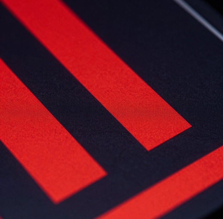 Extreme close-up of a digital interface with stark red geometric shapes and deep charcoal shadows, harsh directional studio lighting.