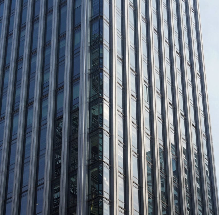 Sharp architectural close-up of a modern corporate skyscraper facade in Mong Kok, steel and glass geometry, cool daylight, high-contrast shadows.