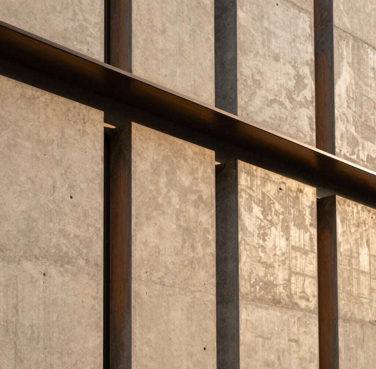 Detail of a contemporary commercial building facade, concrete panels and brushed bronze accents, geometric structural lines, afternoon light, 35mm lens.