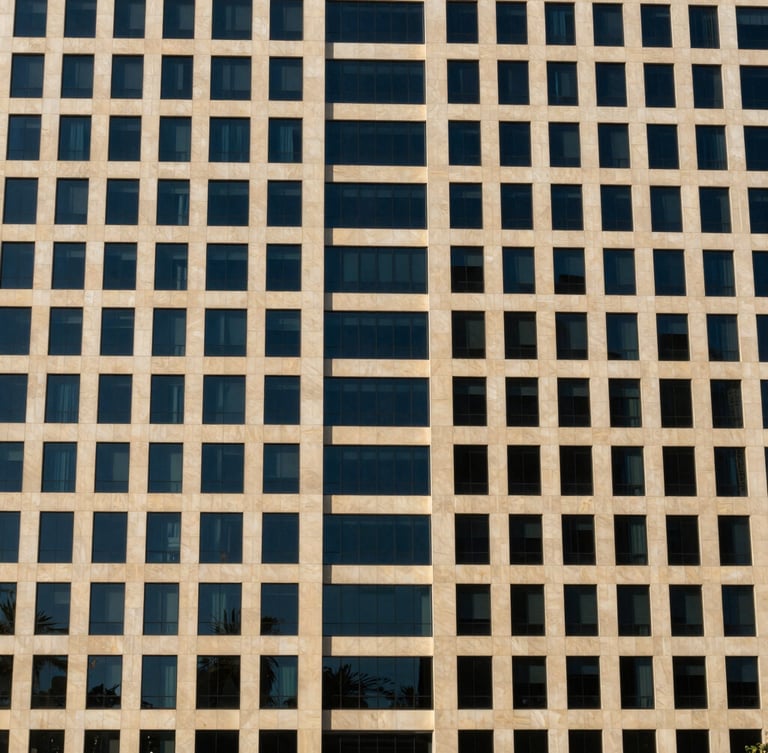 Sharp editorial photography of modern corporate architectural facade in Dubai, bright daylight, deep navy shadows, crisp 35mm lens