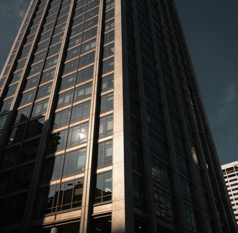 Low-angle heroic architectural shot of a modern glass-and-steel office tower in Singapore, sharp sunlight hitting the facade, dramatic low-key shadows, Hasselblad medium format