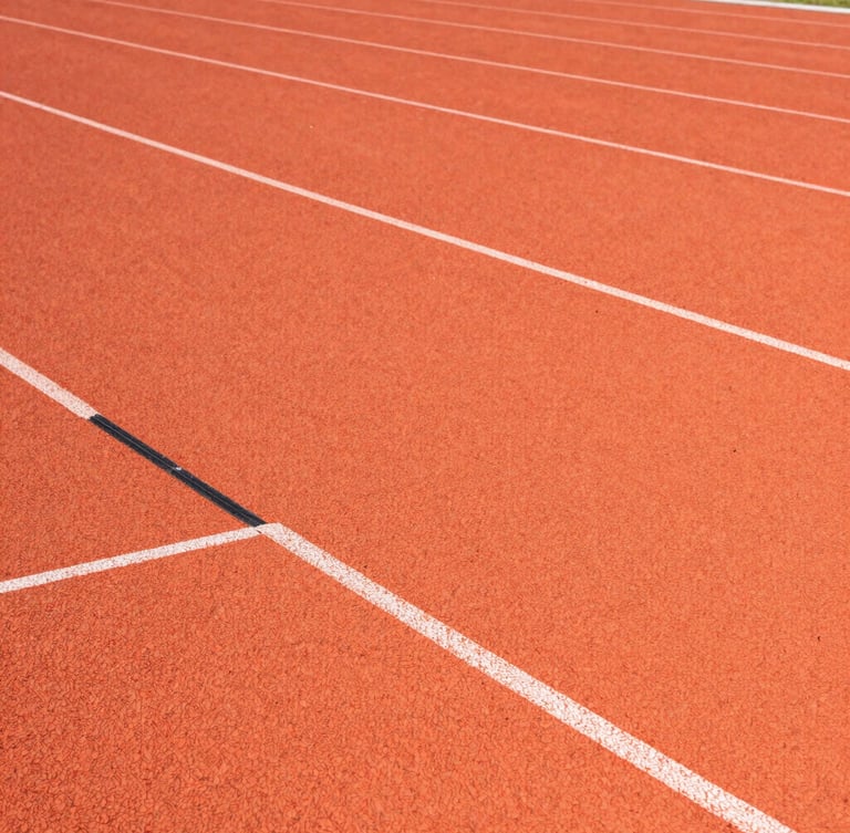Close-up architectural shot of interlocking PP sports tiles, bright crisp stadium floodlights reflecting off the textured orange surface, sharp straight-on angle showing precision joints.