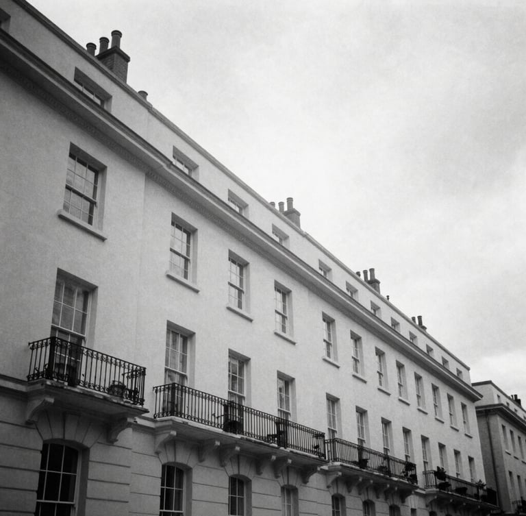 Wide-angle editorial black and white photograph of the sharp architectural lines of Silverstream House in Fitzrovia, soft overcast London daylight, high contrast, 35mm film style