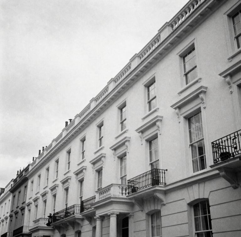 Candid black and white editorial photograph of architectural lines of Silverstream House in Fitzrovia, soft overcast London daylight, sharp shadows, 35mm film.