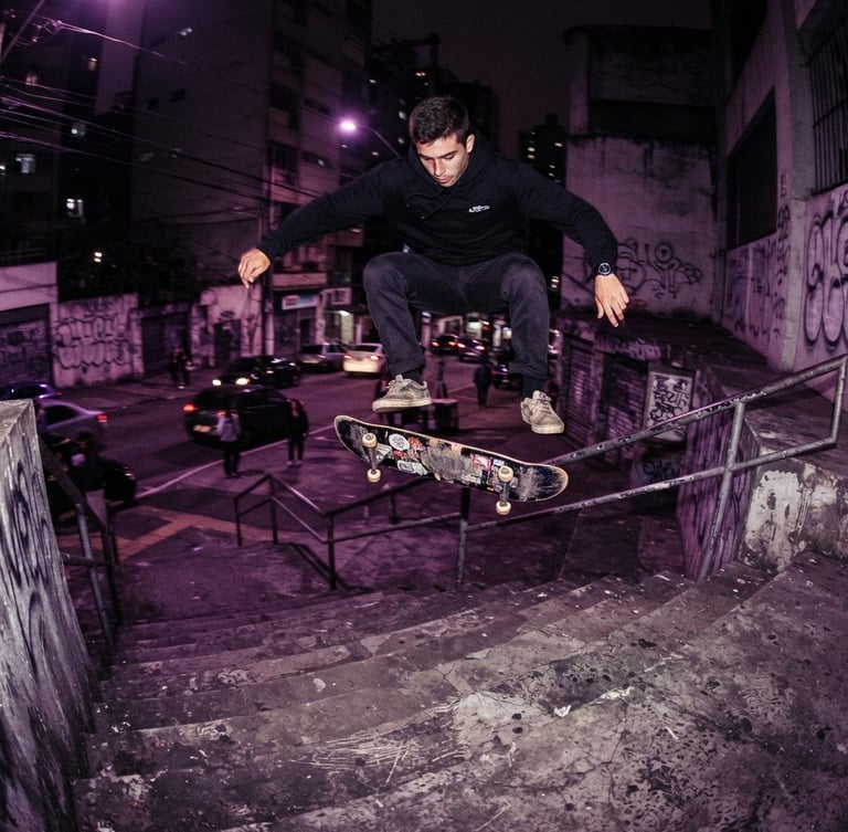 Dynamic low-angle action shot of a skateboarder performing a trick over concrete stairs in São Paulo at night, dramatic purple and magenta streetlights, gritty urban texture, 35mm film