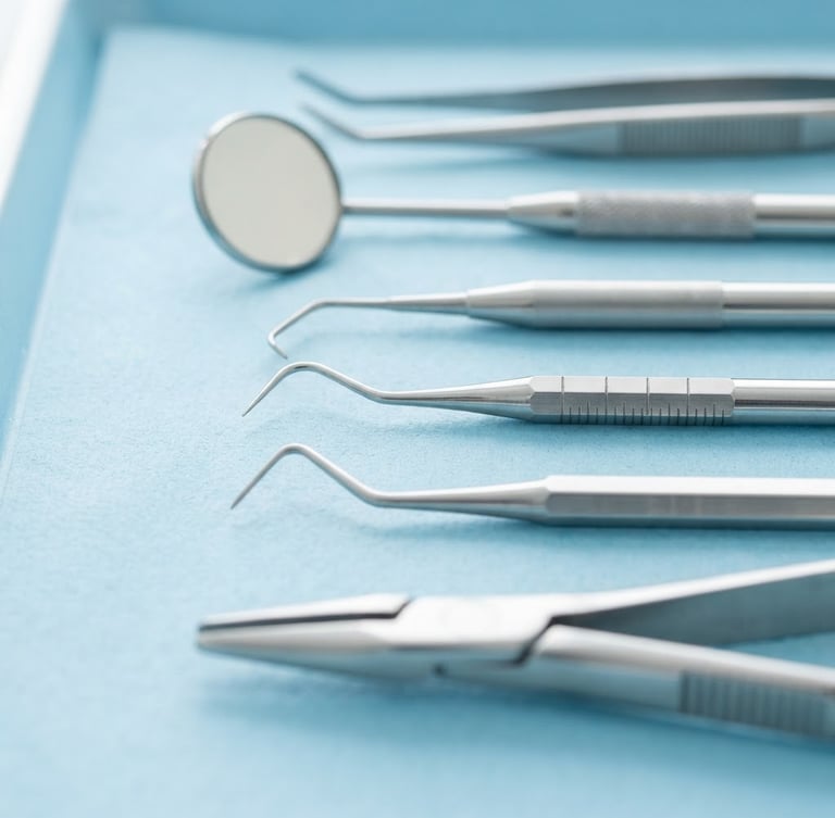 Macro shot of clean dental hygiene tools on a sterile light blue surface, bright clinical daylight, sharp focus