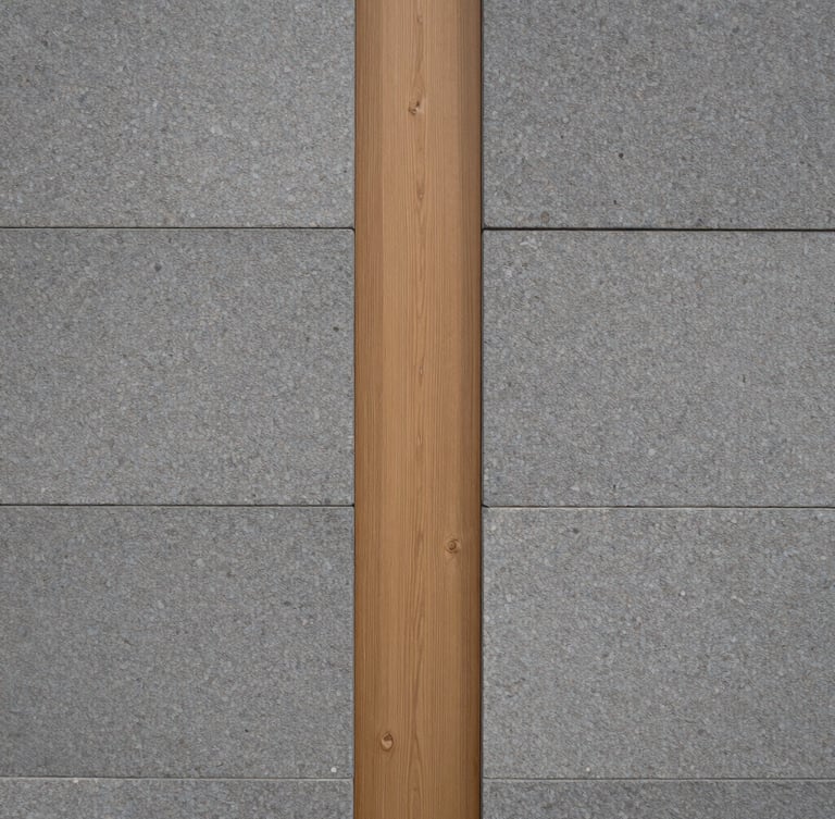 Close-up architectural detail of a modern limestone wall meeting a warm light oak wood panel, soft side lighting, minimalist Scandinavian design.