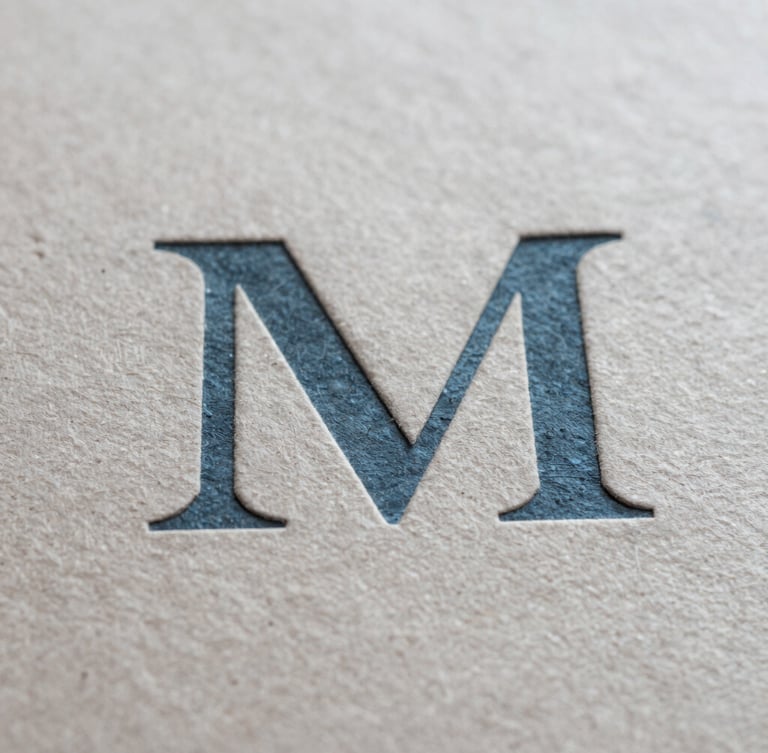 Macro close-up of textured paper and debossed slate blue typography, soft natural light