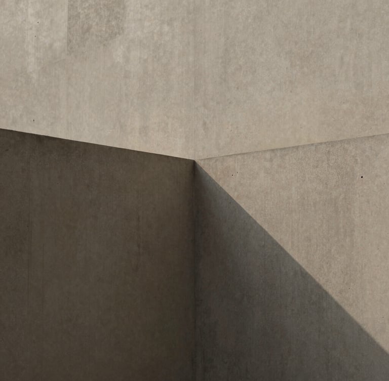 Minimalist editorial photograph of concrete architectural planes intersecting under soft diffused daylight, gentle shadows, muted slate and coffee tones, tactile textures.