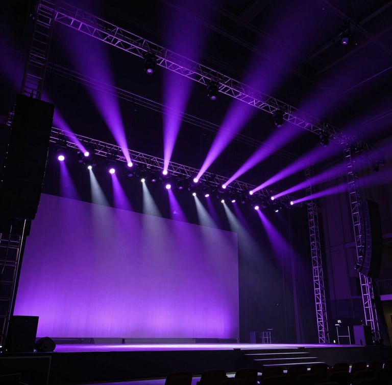 Extreme wide-angle shot of a massive, custom-built corporate stage illuminated by sharp violet spotlights, deep shadows, structural metal trusses visible, raw industrial scale.