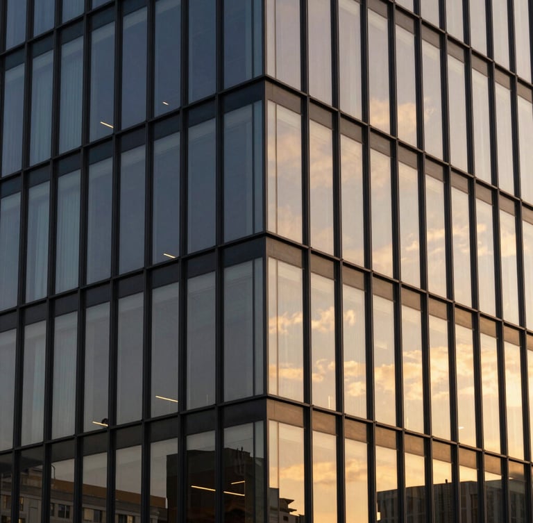 Architectural lines of a modern office building in Ponta Grossa, warm sunset light reflecting on glass panels, clean geometric composition