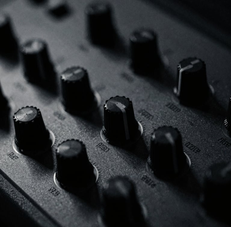 Extreme close-up of vintage synthesizer knobs, low-key chiaroscuro lighting, desaturated monochrome with cold blue undertones, grainy 35mm film