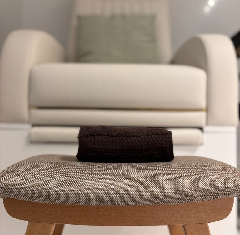 image of a stool, towel and a manicure chair