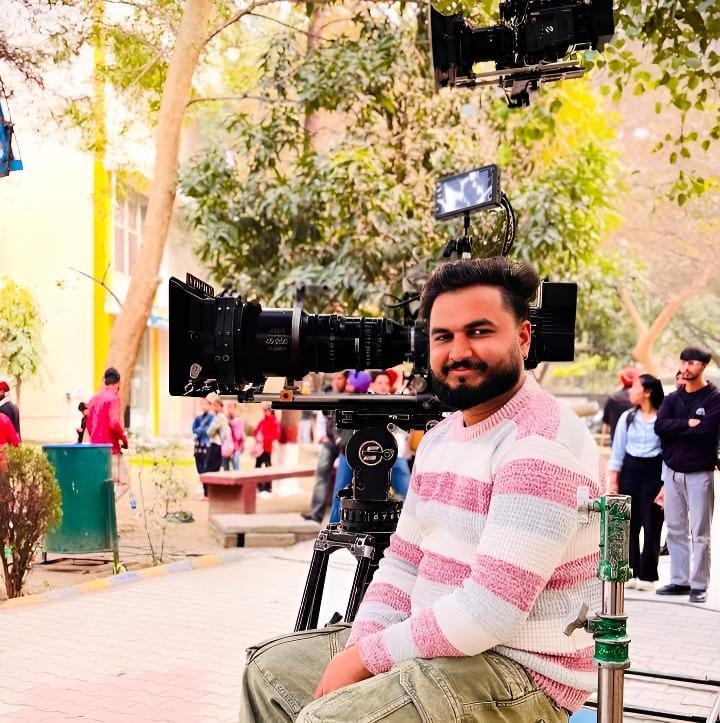 sukhvinder singh sitting on a bench in front of a camera