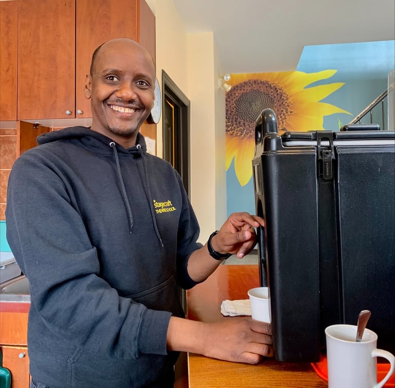 a man in a black jacket and a coffee mug at capital city mission