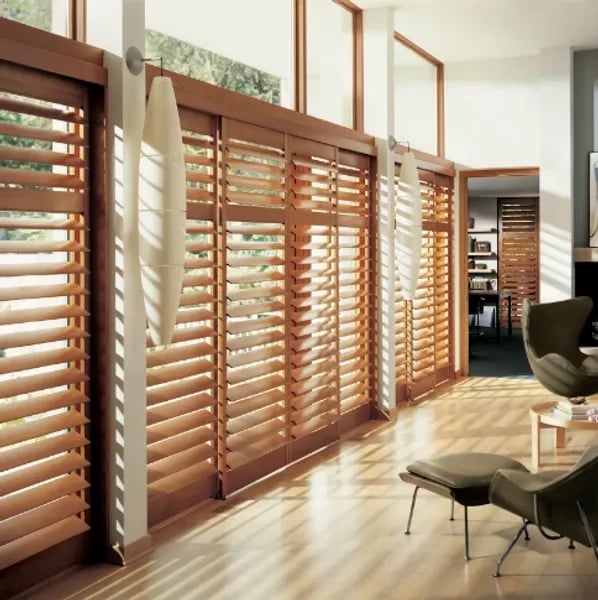 living room with large wood shutters filtering sunlight – Rise Up Window Coverings Milwaukee