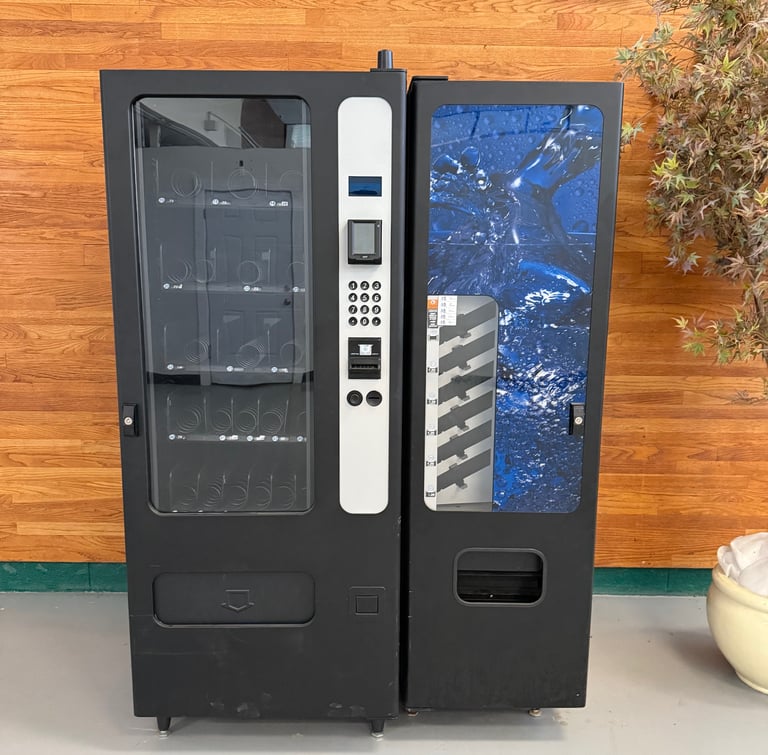 a vending machine with a plant in the background