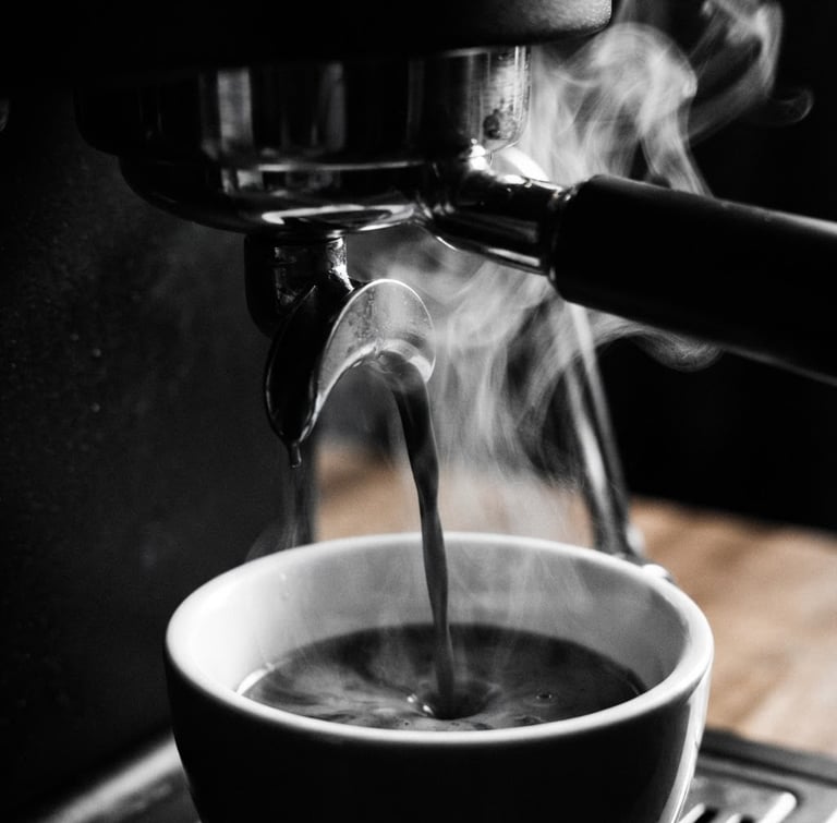 Tight macro shot of dark espresso extraction, steam rising against a dark, high-contrast background, 35mm lens, minimalist monochrome café photography, deep blacks, crisp whites.