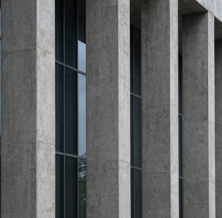 Abstract architectural crop of concrete columns and glass, cool diffused daylight, sharp geometric shadows, wide angle