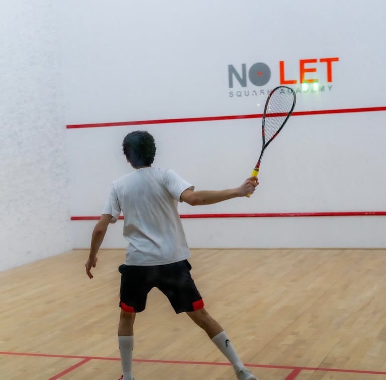 a man in a white shirt is playing squash