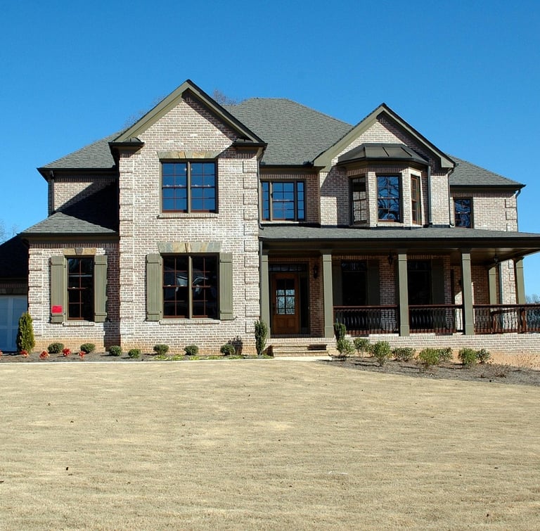 a large house with a large concrete driveway 