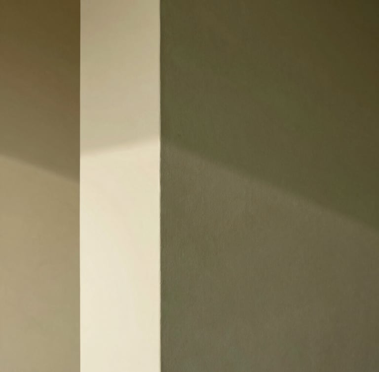 A tall, narrow architectural composition of a plaster wall, natural light casting a soft, directional shadow across a crisp transition from matte olive to warm eggshell finish.