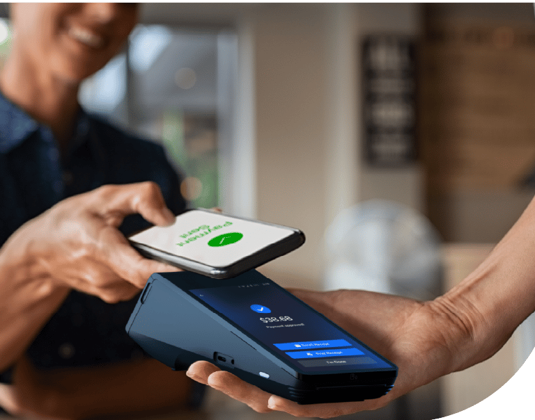 Customer making a contactless mobile payment with a smartphone at a credit card terminal.