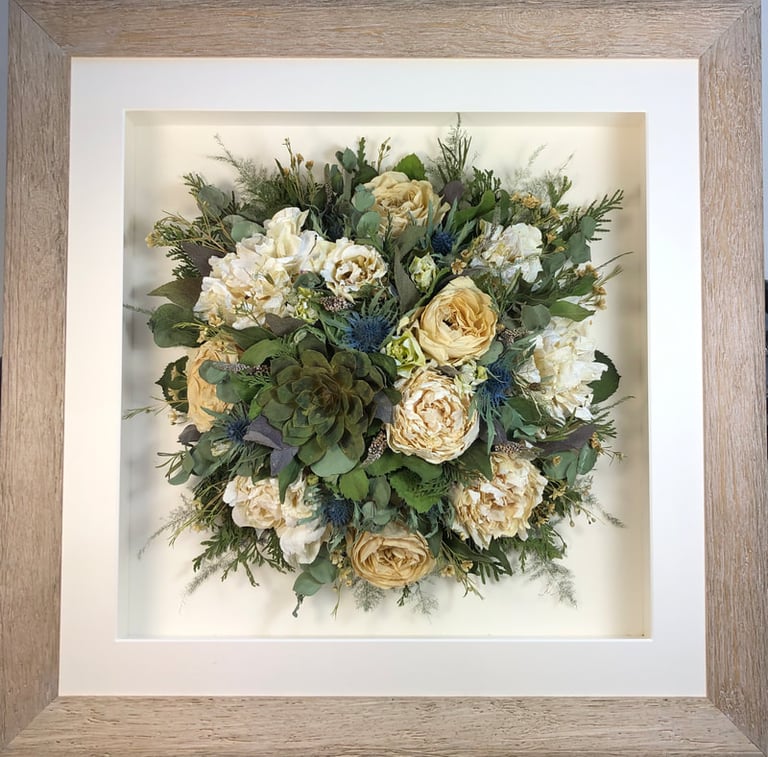Birdseye view preserved wedding bouquet with succulents and peonies in a frame