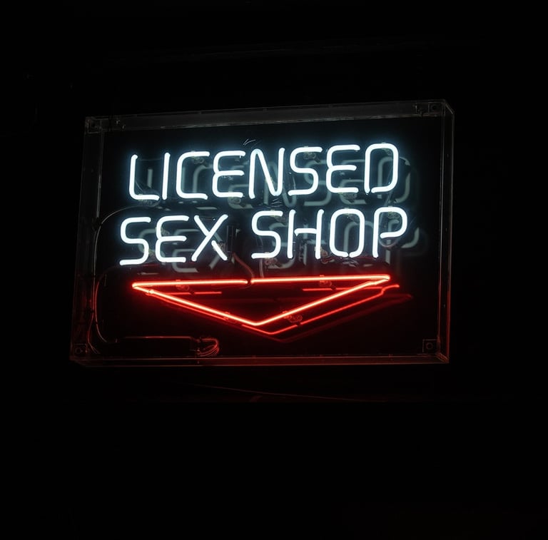 neon sign that reads licensed sex shop