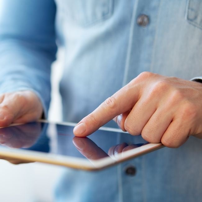 man using business software on tablet