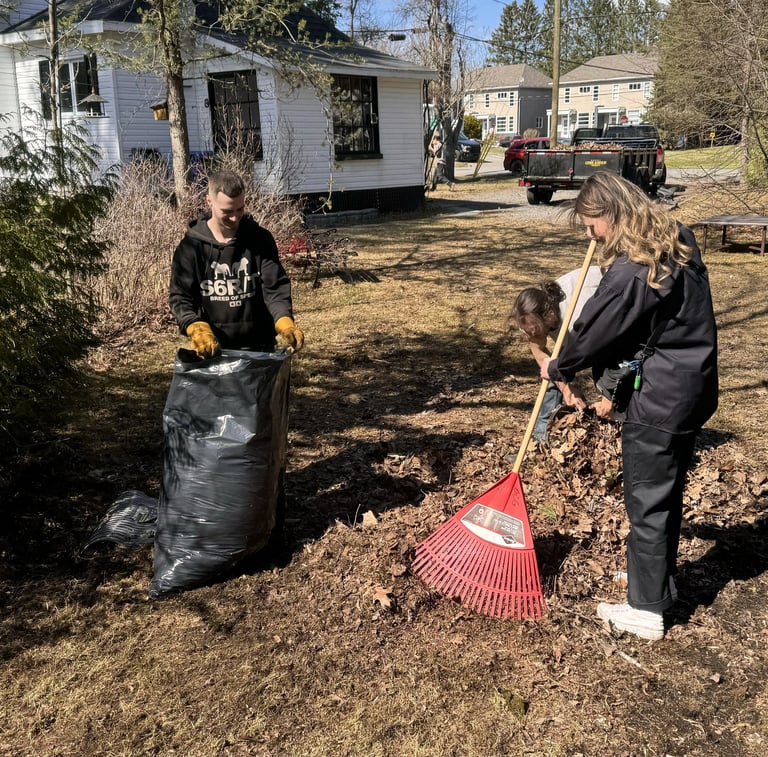 employees raking leaves with gcg truck in the backround