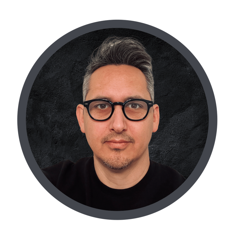 Image of the author with glasses and a black shirt