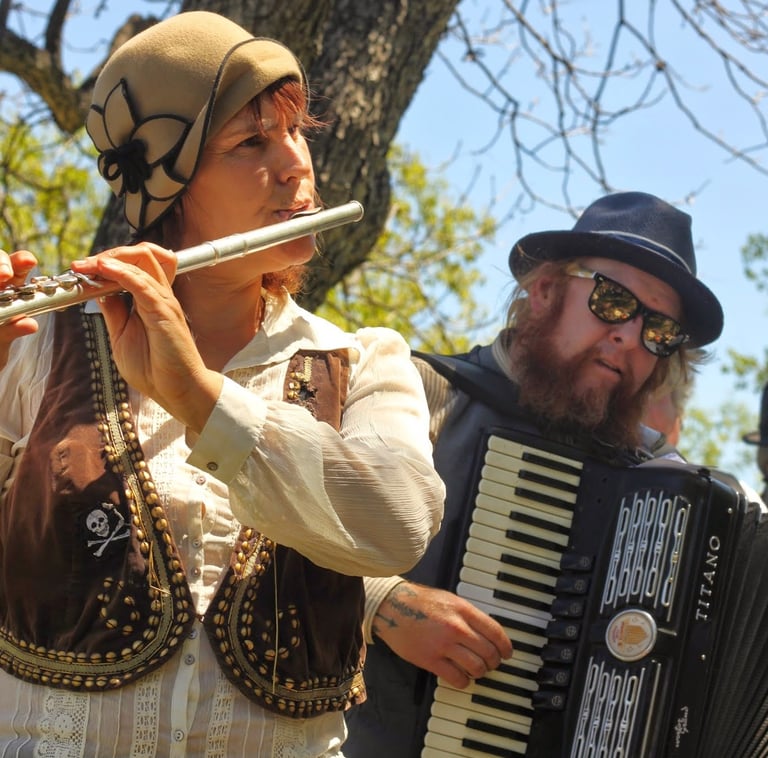 Mazel Tov Kocktail Hour founders playing flute and accordion at a show.