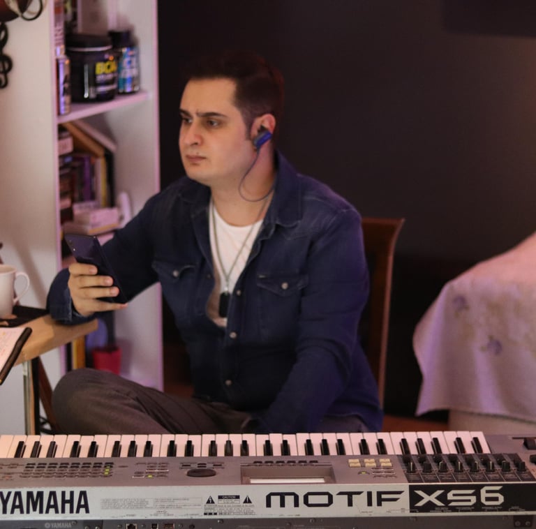a man sitting at a desk with a keyboard and a keyboard