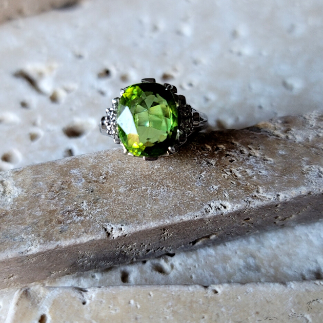 Peridot ring placed on limestone rock