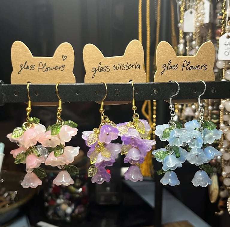 a trio of earrings with clusters of pastel glass flowers on them