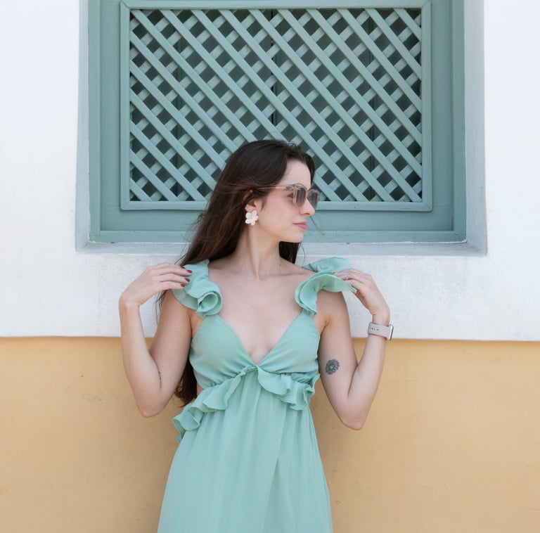 young woman in turquoise dress and sunglasses