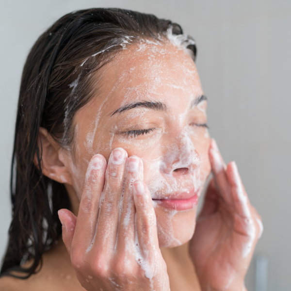 woman exfoliating her face