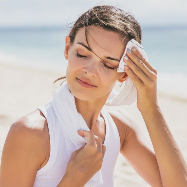 woman wiping sweat off of her face