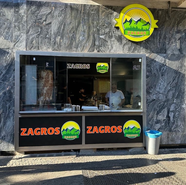 a restaurant with a large window and a sign that says  logo zagros gemüse kebap berlin