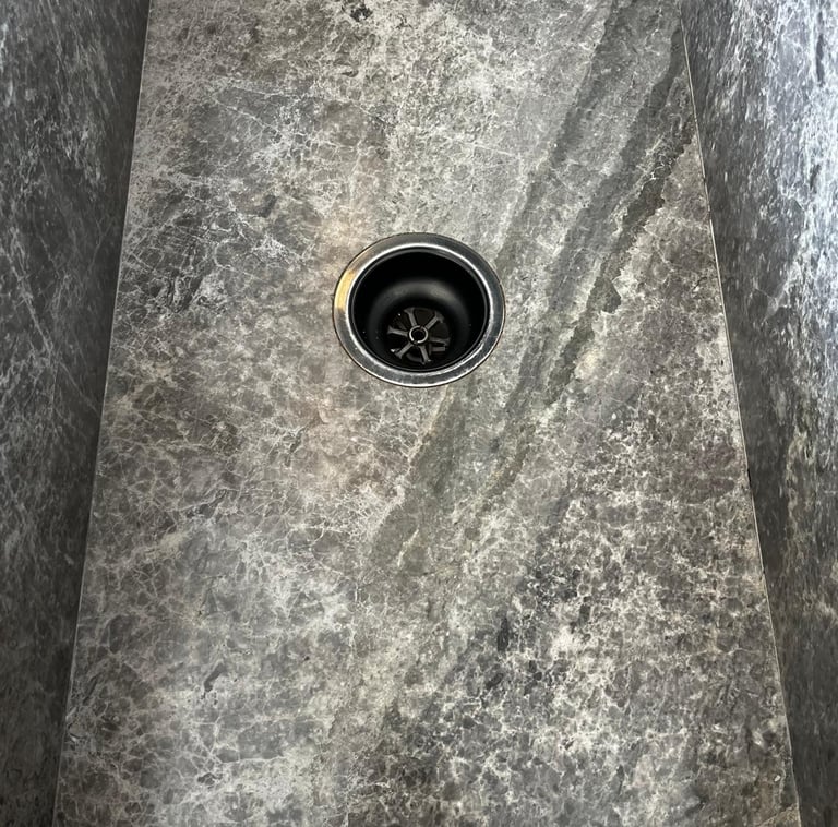 Custom stone sink cutout and installation with precise drilling for tap outlets in Melbourne