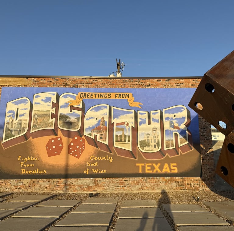 Decatur mural that says "Greetings from Decatur Texas. Eighter from Decatur. County seat of Wise."