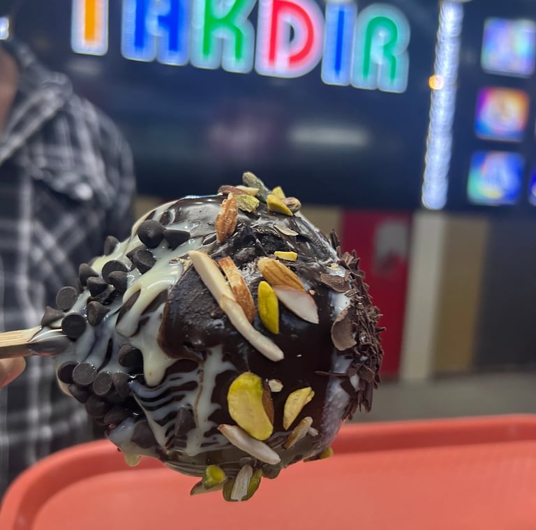 a chocolate covered dessert on a plate with a man in a plaid shirt