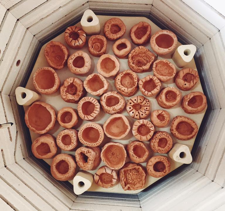 a set of pinch pot clay creations in a kiln